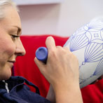 Rhian Malin decorating a mandala bottle in her workshop 2019